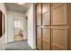 Hallway features carpet, built-in storage, and leads to a bathroom with shuttered window at 902 Cripple Creek Ct, Henderson, NV 89014