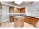 A kitchen featuring wooden cabinets, granite countertops, stainless steel appliances, and tile flooring at 902 Cripple Creek Ct, Henderson, NV 89014