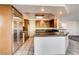 A well-lit kitchen boasting stainless steel appliances, tile flooring, granite countertops, and classic wooden cabinetry at 902 Cripple Creek Ct, Henderson, NV 89014