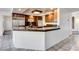 A kitchen featuring granite countertops, stainless steel appliances, dark wooden cabinets, and tile flooring at 902 Cripple Creek Ct, Henderson, NV 89014