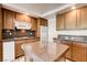 Kitchen with wooden cabinets, granite countertops, stainless steel appliances, and tile flooring at 902 Cripple Creek Ct, Henderson, NV 89014