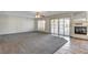Expansive living room with a cozy fireplace, shuttered windows, and views of the pool at 902 Cripple Creek Ct, Henderson, NV 89014