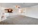 Open-concept living room with a ceiling fan, carpeting, and a view of the kitchen at 902 Cripple Creek Ct, Henderson, NV 89014
