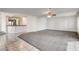 Open living room with carpet, tile entry, and access to elevated dry bar area at 902 Cripple Creek Ct, Henderson, NV 89014