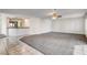 An open living space features new carpet, tile floors, and a mirrored bar area for entertaining at 902 Cripple Creek Ct, Henderson, NV 89014