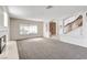 Spacious living room with large windows and a fireplace, perfect for entertaining guests or relaxing with Gathering at 902 Cripple Creek Ct, Henderson, NV 89014