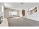 Open-concept living area with fireplace, large windows, and views of the staircase and entry at 902 Cripple Creek Ct, Henderson, NV 89014