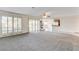 Large open living room with new carpeting, a fireplace, and an open concept layout leading to the kitchen at 902 Cripple Creek Ct, Henderson, NV 89014