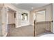 Open loft area with carpet, French doors, and natural light, creating a versatile space at 902 Cripple Creek Ct, Henderson, NV 89014