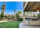 Charming outdoor kitchen complete with built-in grill, mini fridge, and covered patio at 902 Cripple Creek Ct, Henderson, NV 89014