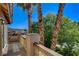 Patio featuring decorative railing with lush greenery and views of neighboring landscape at 902 Cripple Creek Ct, Henderson, NV 89014