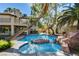 Beautiful backyard with inviting pool, rock accents, and spa, perfect for relaxation and outdoor entertaining at 902 Cripple Creek Ct, Henderson, NV 89014