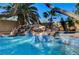 Backyard pool showcasing rock waterfall, mosaic tile accents, and inviting steps for easy access and relaxation at 902 Cripple Creek Ct, Henderson, NV 89014