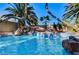 Beautiful pool with rock waterfall feature, lush landscaping, and a serene ambiance for ultimate relaxation at 902 Cripple Creek Ct, Henderson, NV 89014