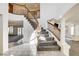 Elegant foyer showcasing a curved staircase with wooden railings and views of the living spaces at 902 Cripple Creek Ct, Henderson, NV 89014