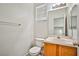 Bright half bathroom with a pedestal sink and a window allowing natural light at 9122 Mountain Maple Ct, Las Vegas, NV 89148