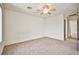 Neutral bedroom with a ceiling fan and carpet flooring at 9122 Mountain Maple Ct, Las Vegas, NV 89148