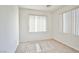 Sunny bedroom with two large windows, plush carpet, and neutral walls at 9122 Mountain Maple Ct, Las Vegas, NV 89148
