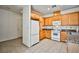 Bright kitchen with ample wood cabinetry, white appliances, and tile flooring at 9122 Mountain Maple Ct, Las Vegas, NV 89148