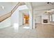 Spacious living area with tile flooring, fireplace, high ceilings, and an open view into the kitchen at 9122 Mountain Maple Ct, Las Vegas, NV 89148