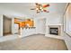 Open-concept living area featuring tile floors, a fireplace, and wooden cabinets at 9122 Mountain Maple Ct, Las Vegas, NV 89148