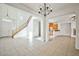 Open floor plan with tile flooring, a staircase with wooden railings, and ample natural light at 9122 Mountain Maple Ct, Las Vegas, NV 89148