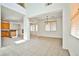 Open living area with tile floors, high ceilings, fireplace, and kitchen view at 9122 Mountain Maple Ct, Las Vegas, NV 89148