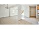 Open living room with tile floors, stairs, neutral paint, and large windows at 9122 Mountain Maple Ct, Las Vegas, NV 89148