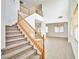 Carpeted staircase with wooden railing and view of the open floor plan and airy living spaces at 9122 Mountain Maple Ct, Las Vegas, NV 89148
