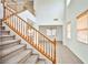 Carpeted staircase with wooden railing leading to the second floor, showcasing the bright and open layout at 9122 Mountain Maple Ct, Las Vegas, NV 89148