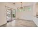 Dining area with modern light fixture and sliding glass door to patio at 9516 City Hill Ct, Las Vegas, NV 89134