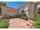 Inviting front patio area with brick pavers, landscaping, and stucco exterior at 9516 City Hill Ct, Las Vegas, NV 89134