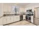 Well-lit kitchen featuring stainless steel appliances and white cabinets at 9516 City Hill Ct, Las Vegas, NV 89134