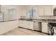 Modern kitchen featuring stainless steel appliances and a breakfast bar overlooking the dining area at 9516 City Hill Ct, Las Vegas, NV 89134