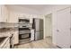 Bright kitchen with stainless steel appliances, granite countertops, and a door to a hallway at 9516 City Hill Ct, Las Vegas, NV 89134