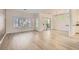 Bright and spacious living room with wood flooring, large windows, and sliding glass doors at 9516 City Hill Ct, Las Vegas, NV 89134