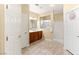 Well-lit bathroom features double sinks, wooden cabinets, and a separate shower stall at 10463 Pioneer Park Ave, Las Vegas, NV 89135