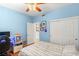 Cozy bedroom with blue walls, ceiling fan, and closet, perfect for a relaxing retreat at 10463 Pioneer Park Ave, Las Vegas, NV 89135