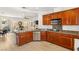 Open-concept kitchen featuring wood cabinets, granite counters, and stainless steel appliances at 10463 Pioneer Park Ave, Las Vegas, NV 89135