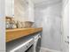 Well-equipped laundry room with modern washer and dryer and white cabinets for storage at 10463 Pioneer Park Ave, Las Vegas, NV 89135