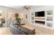 Open-concept living room with modern fireplace and entertainment center, plus stylish wood flooring at 10463 Pioneer Park Ave, Las Vegas, NV 89135
