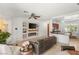 Bright and airy living space with fireplace, kitchen bar, and comfortable seating at 10463 Pioneer Park Ave, Las Vegas, NV 89135