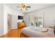 Bright main bedroom with a ceiling fan, modern dresser, and windows with stylish shutters at 10463 Pioneer Park Ave, Las Vegas, NV 89135
