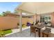 Inviting covered patio with dining table and seating, ideal for outdoor entertaining at 10463 Pioneer Park Ave, Las Vegas, NV 89135