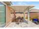 Cozy covered patio with dining set, perfect for enjoying outdoor meals and relaxation at 10463 Pioneer Park Ave, Las Vegas, NV 89135