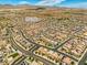Aerial view of neighborhood featuring many single Gathering homes and desert landscape at 106 Rock Crossing Ave, North Las Vegas, NV 89031