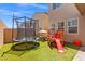 Large backyard featuring a trampoline, play structure, and plenty of space for recreation at 106 Rock Crossing Ave, North Las Vegas, NV 89031