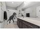 Charming bathroom features a dinosaur-themed shower curtain and a dark wood vanity at 106 Rock Crossing Ave, North Las Vegas, NV 89031