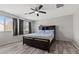 Bedroom features a dark wood bed frame, light blue bedding, and two windows at 106 Rock Crossing Ave, North Las Vegas, NV 89031