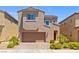 Two-story home featuring a two-car garage, desert landscaping, and a charming arched window at 106 Rock Crossing Ave, North Las Vegas, NV 89031